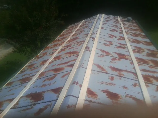 Rusted metal roof panels with new wood purlins before replacement — Storm Damage Roof Repair in Birdsboro by Roofing Brothers